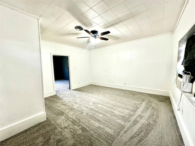 unfurnished room with crown molding, baseboards, ceiling fan, and carpet flooring