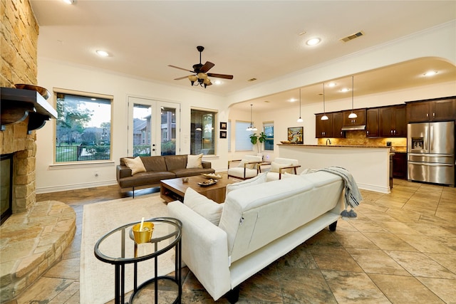 living area with visible vents, recessed lighting, a fireplace, ornamental molding, and french doors