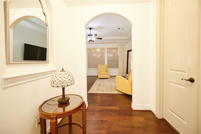 hallway with arched walkways, visible vents, and dark wood-style flooring