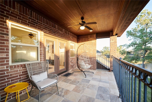 view of patio / terrace with a balcony and a ceiling fan