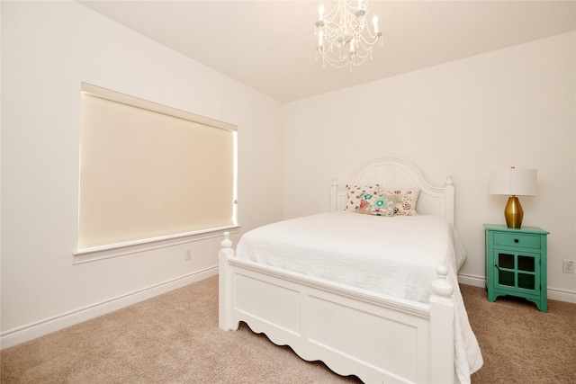 bedroom with light colored carpet, an inviting chandelier, and baseboards