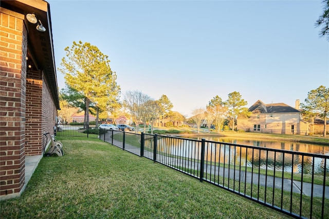 view of yard with fence and a water view