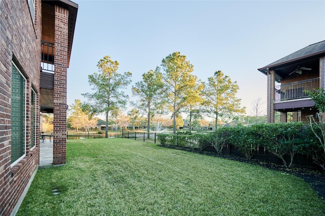 view of yard featuring a ceiling fan and a fenced backyard