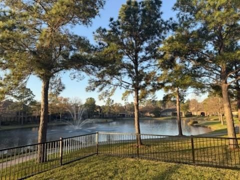 property view of water featuring fence