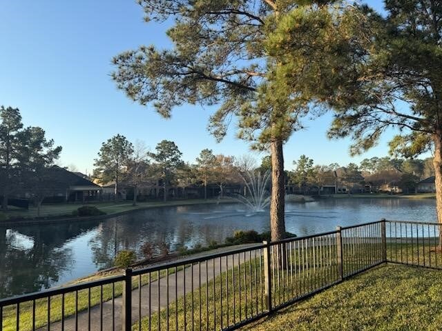 property view of water featuring fence