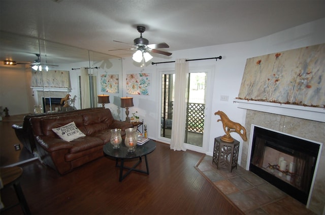 living area featuring wood finished floors and a tile fireplace