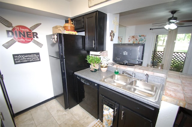 kitchen with a peninsula, light countertops, black appliances, a sink, and light tile patterned flooring