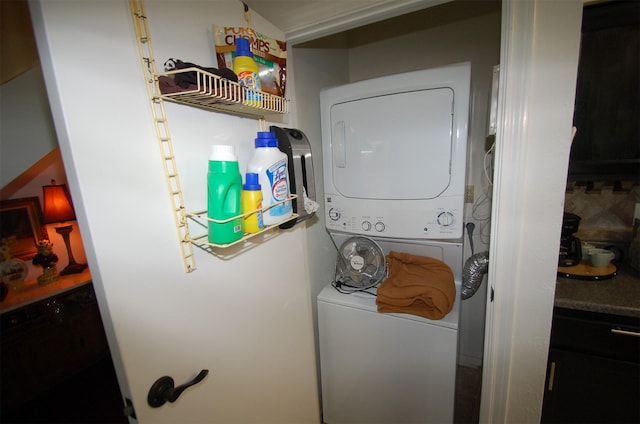 laundry area with stacked washer and dryer and laundry area