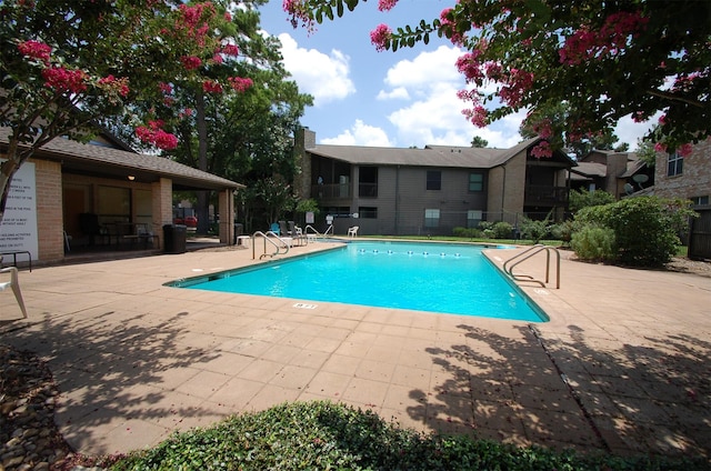 pool featuring a patio and fence