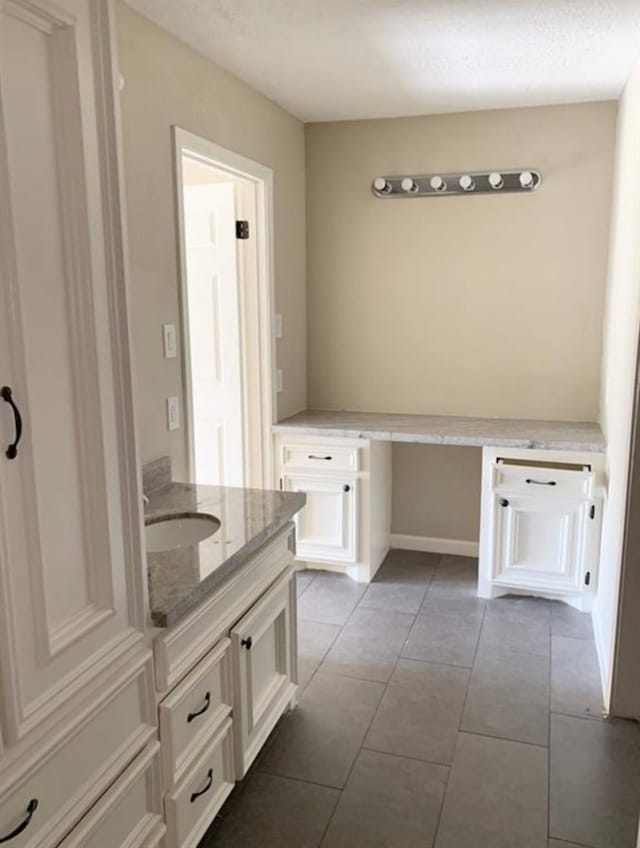 bathroom featuring tile patterned flooring and vanity