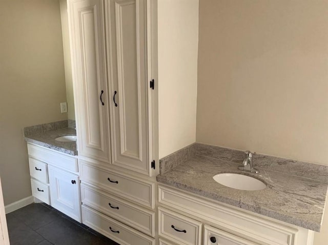 bathroom featuring tile patterned flooring and vanity