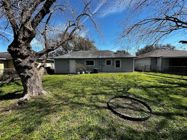 back of property featuring fence, cooling unit, and a yard