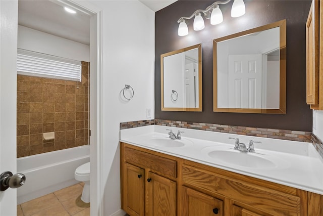 full bath with double vanity, tile patterned flooring, a sink, and toilet