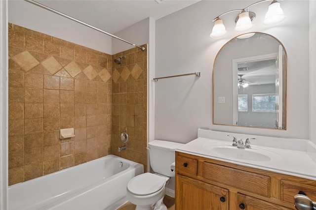 bathroom with bathing tub / shower combination, toilet, and vanity