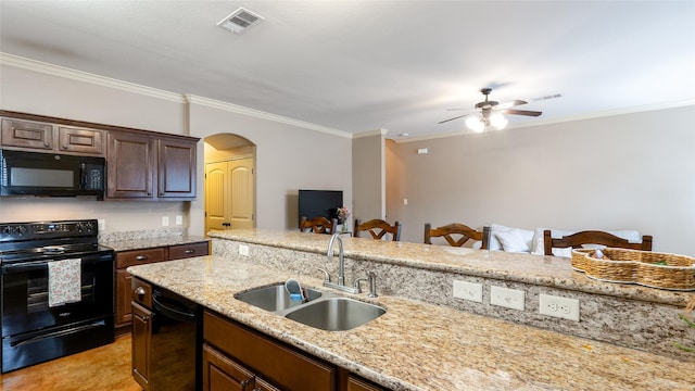 2903 Old Ironsides Dr, College Station, TX 77845 - kitchen with black appliances, ceiling fan, arched walkways, crown molding, and light stone counters