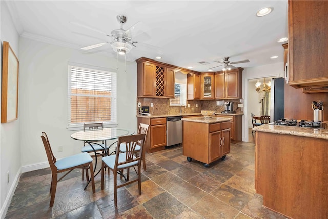 7719 Highmeadow Dr, Houston, TX 77063 - kitchen featuring ceiling fan, appliances with stainless steel finishes, stone tile flooring, and plenty of natural light