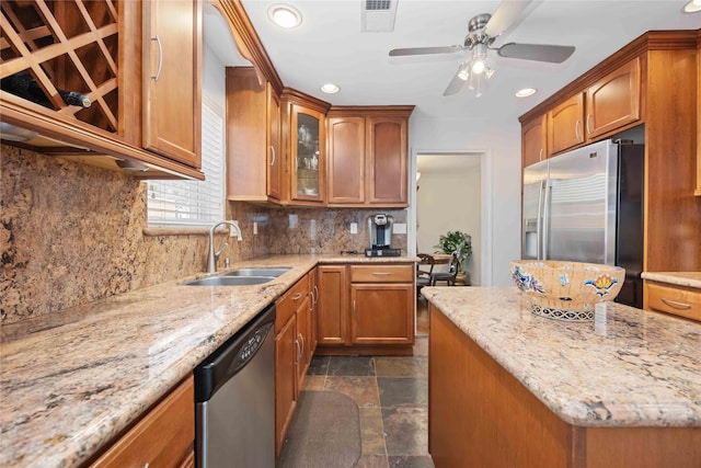 7719 Highmeadow Dr, Houston, TX 77063 - kitchen with appliances with stainless steel finishes, visible vents, brown cabinets, and a sink