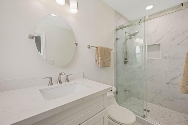 full bath featuring toilet, a shower stall, and vanity