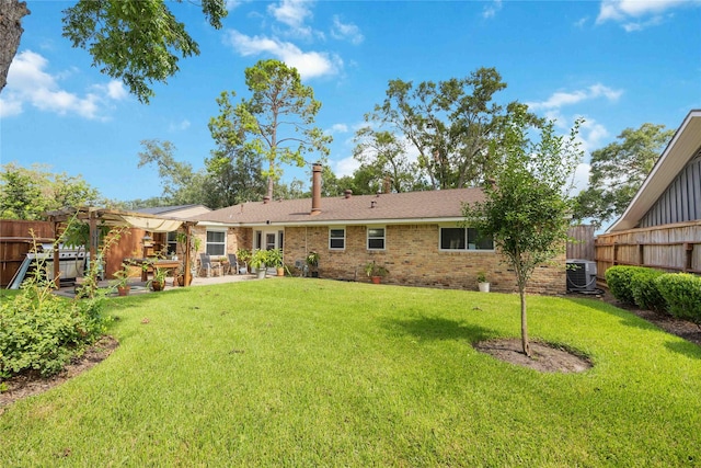 back of house with brick siding, a lawn, central AC unit, a patio area, and fence