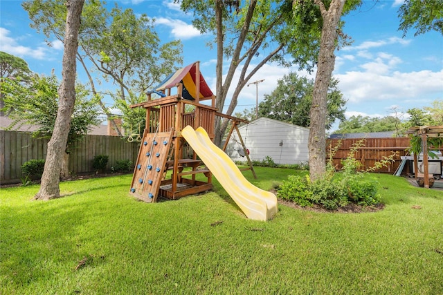 view of jungle gym featuring a lawn and a fenced backyard