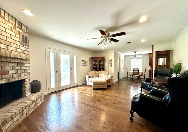 7719 Highmeadow Dr, Houston, TX 77063 - living room with ceiling fan, visible vents, dark wood-style floors, ornamental molding, and a fireplace