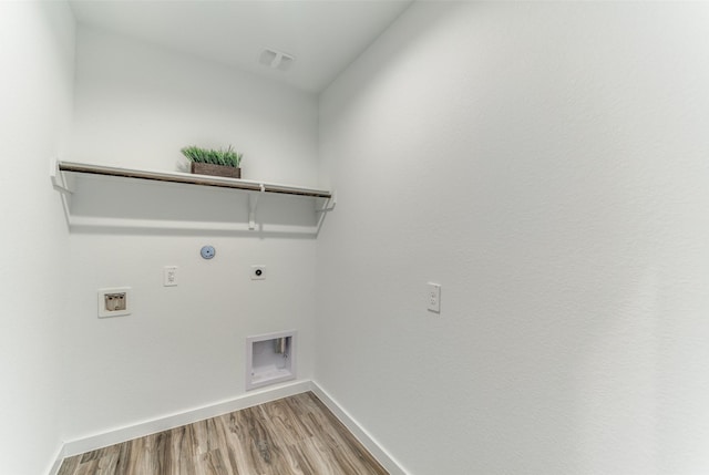 clothes washing area with hookup for a gas dryer, laundry area, washer hookup, light wood-style floors, and electric dryer hookup