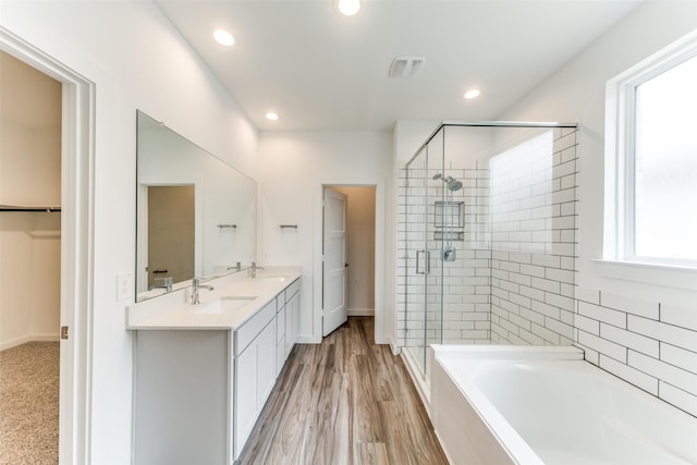 bathroom with recessed lighting, visible vents, a stall shower, a sink, and a bath