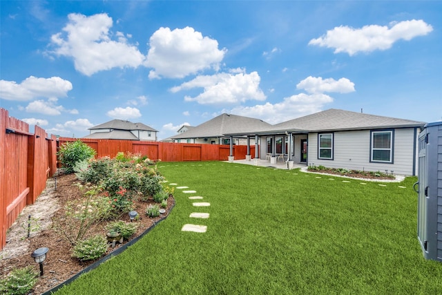 view of yard with a patio area and a fenced backyard