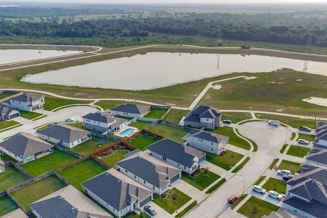 drone / aerial view featuring a residential view and a water view