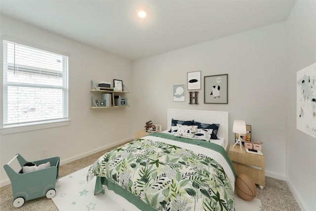 bedroom with carpet floors and baseboards