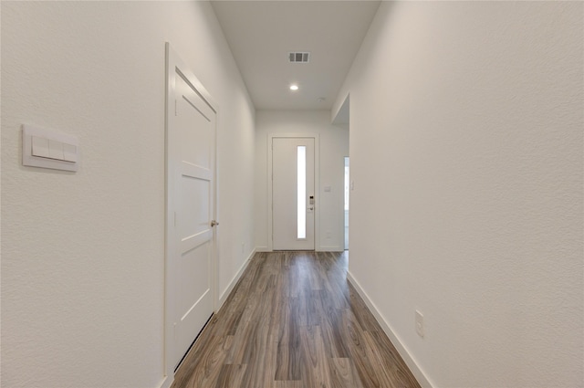 doorway to outside featuring dark wood-style floors, baseboards, visible vents, and recessed lighting