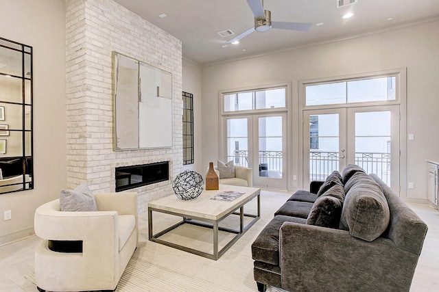 living room with french doors, a fireplace, visible vents, ornamental molding, and baseboards