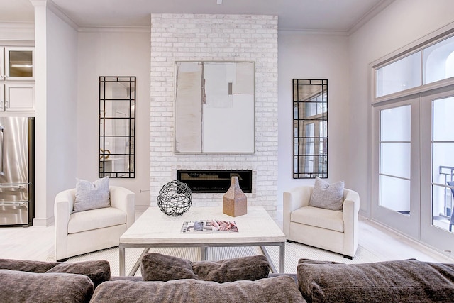 living room with a brick fireplace and crown molding