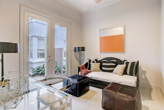 carpeted living room featuring baseboards, ornamental molding, and french doors