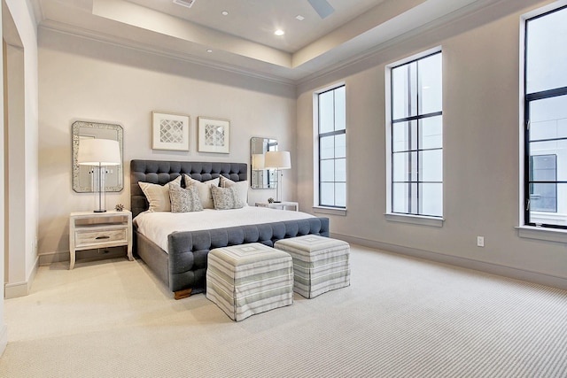 bedroom featuring ornamental molding, carpet floors, a tray ceiling, and baseboards