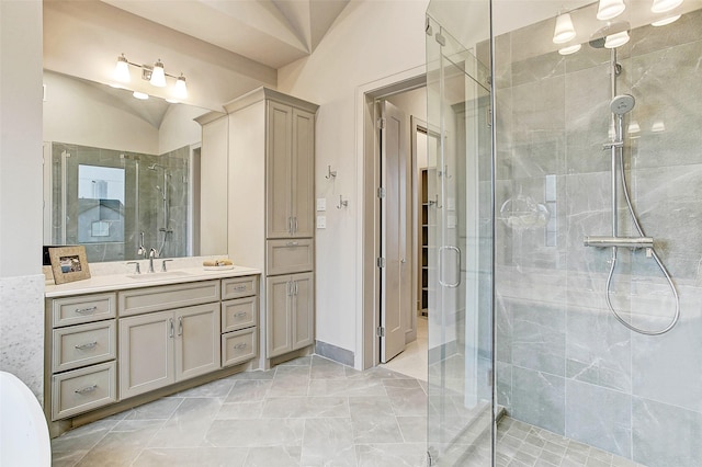 bathroom featuring a stall shower, vaulted ceiling, and vanity