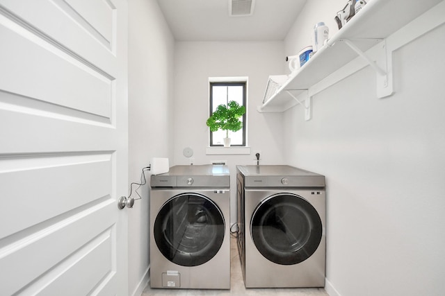 laundry area featuring laundry area, baseboards, visible vents, and washer and dryer