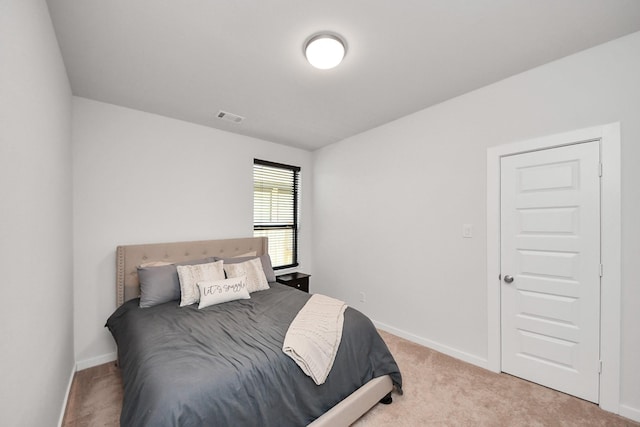 bedroom featuring light colored carpet, visible vents, and baseboards