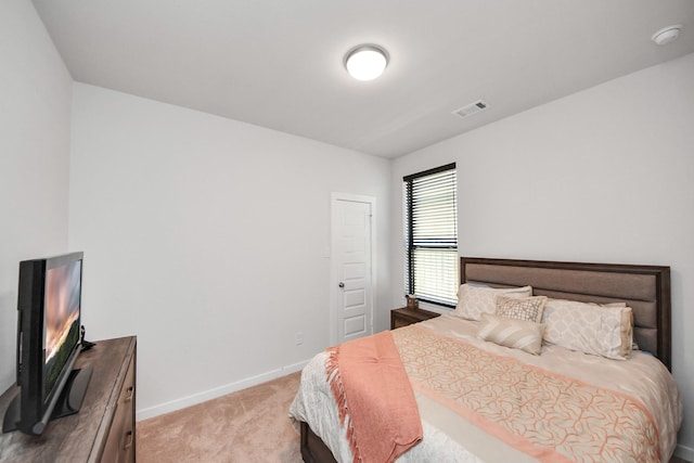 bedroom with light carpet, visible vents, and baseboards