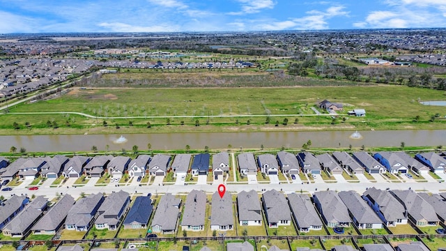 birds eye view of property with a residential view and a water view