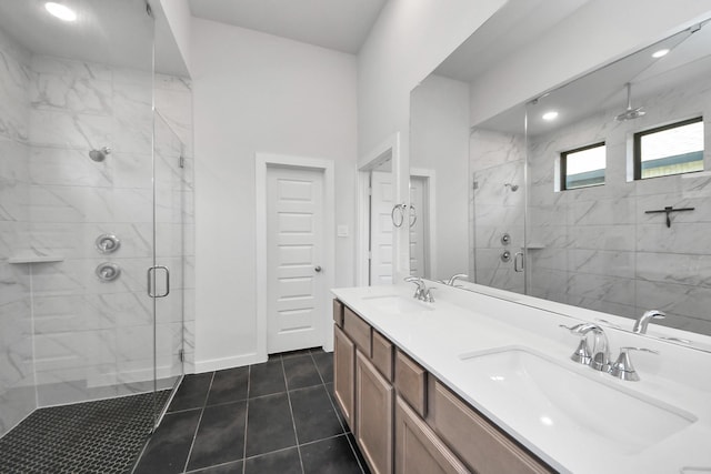 full bathroom featuring double vanity, a stall shower, a sink, and tile patterned floors