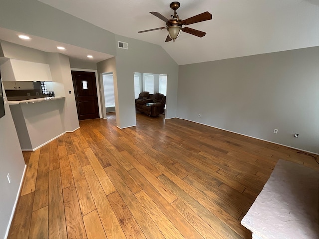 unfurnished living room featuring lofted ceiling, visible vents, ceiling fan, and hardwood / wood-style flooring