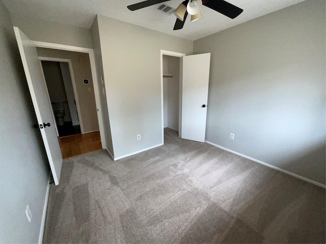 unfurnished bedroom with carpet, baseboards, visible vents, and a closet