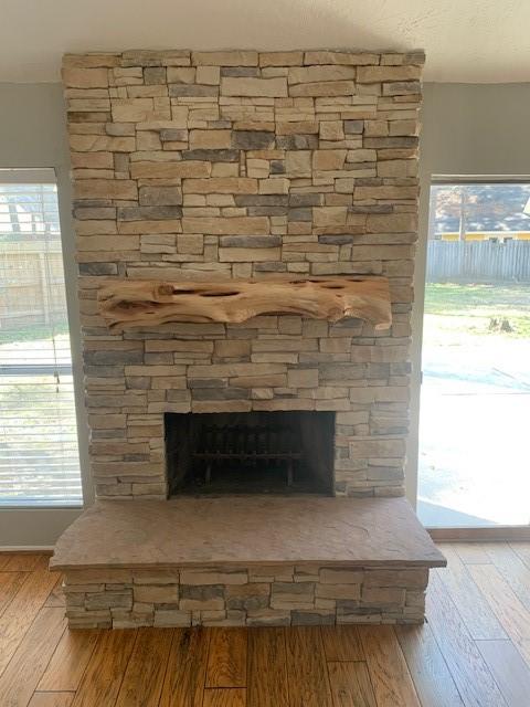 interior details featuring a fireplace and wood finished floors