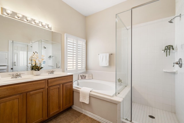 full bathroom featuring double vanity, a stall shower, a bath, tile patterned flooring, and a sink