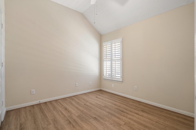 unfurnished room with a ceiling fan, lofted ceiling, baseboards, and wood finished floors