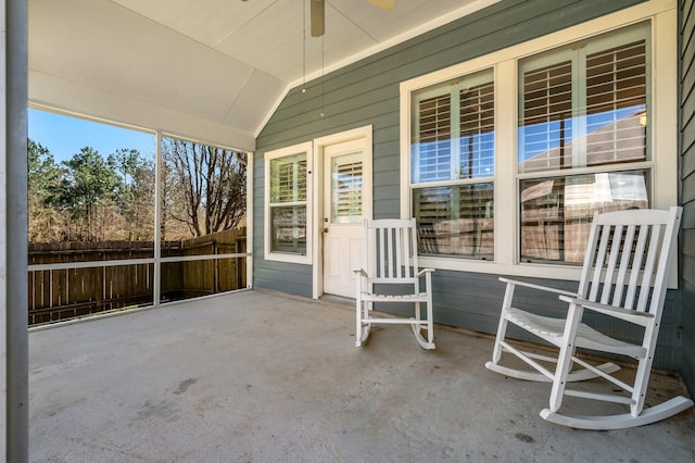 unfurnished sunroom with lofted ceiling and ceiling fan