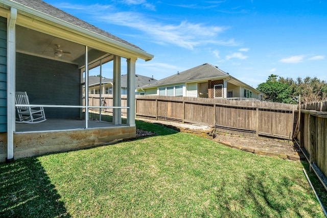 view of yard with a sunroom and a fenced backyard