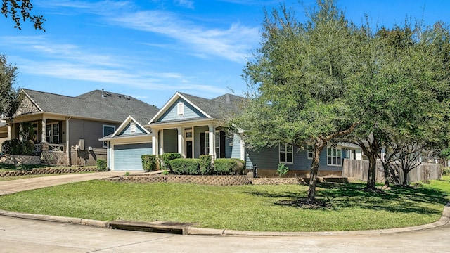 view of front of property featuring a garage, fence, driveway, and a front lawn