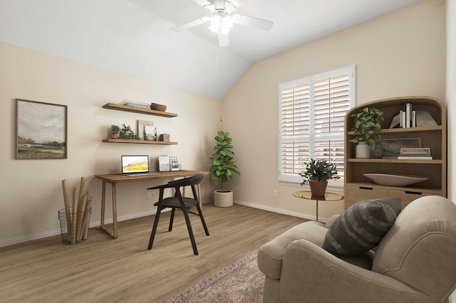 office area featuring lofted ceiling, wood finished floors, a ceiling fan, and baseboards